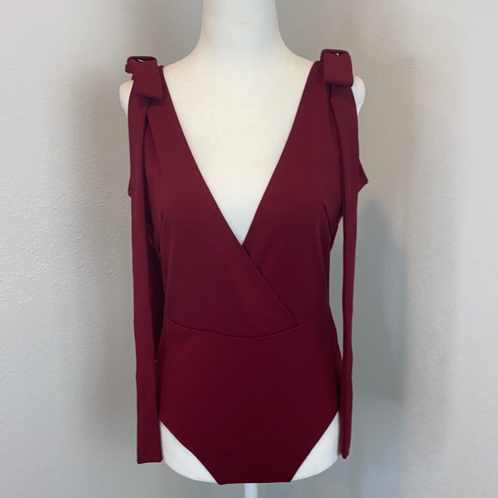 NWT “Oh My Love “ burgundy sleeveless bodysuit with bow accent. Size Med…